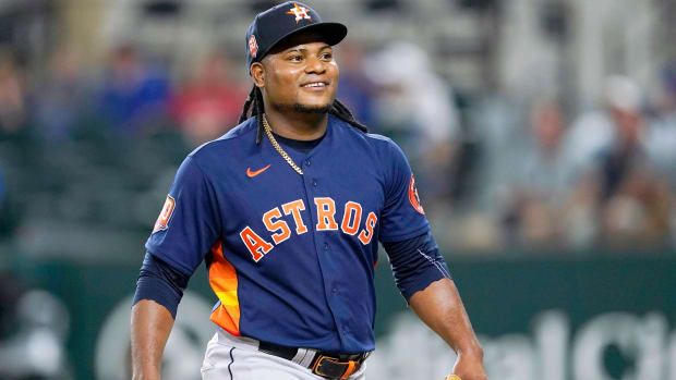 Houston Astros’ Framber Valdez smiles as he walks to the dugout after working against the Texas Rangers during the eighth inning of a baseball game in Arlington, Texas, Tuesday, Aug. 30, 2022.